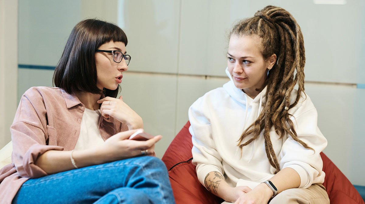 A marketing team analysing customer reviews and trust metrics on laptops and a big screen, illustrating Authenticity and Trust in Marketing in 2025.